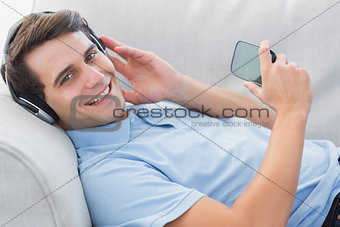Portrait of a man enjoying music with his smartphone