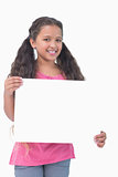 Little girl holding and presenting sign at camera
