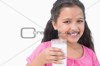 Smiling little girl drinking milk