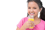 Cheerful little girl drinking orange juice