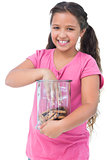 Little girl taking a cookie from jar