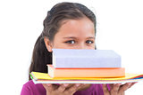 Little girl holding her homework and looking at camera