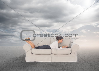 Elegant businesswoman lying on couch