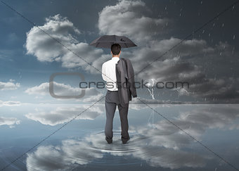 Businessman holding a black umbrella