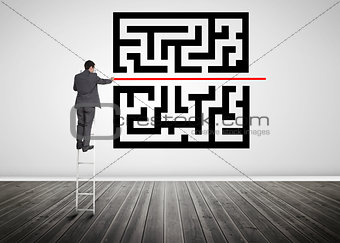 Businessman standing on a ladder drawing red line through qr code