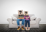Funny couple wearing boxes with question mark on their head