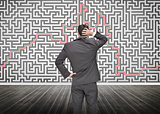 Puzzled businessman looking at a maze