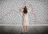 Puzzled businesswoman looking at a maze