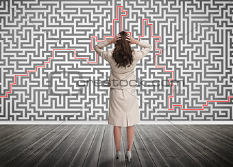 Puzzled businesswoman looking at a maze