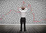 Confused businessman looking at a maze