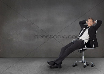 Handsome businessman resting in his swivel chair