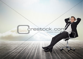 Smiling businessman sitting in a swivel chair