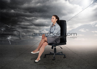 Businesswoman sitting in middle of opposite weather settings