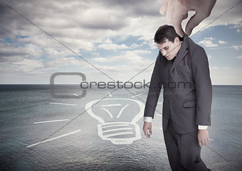 Giant hand dropping off a businessman on a surface