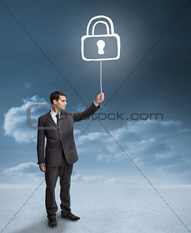 Businessman holding a floating padlock