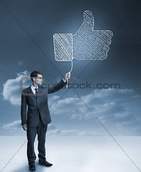 Businessman holding a blue giant thumb up
