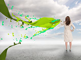 Creative businesswoman with green paint splash