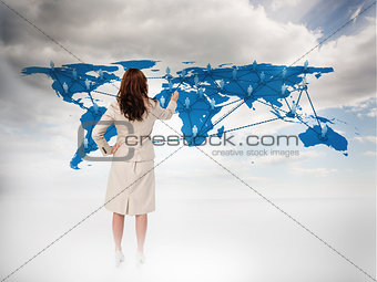Businesswoman touching at a world map