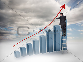 Businessman drawing a red arrow over a growing chart