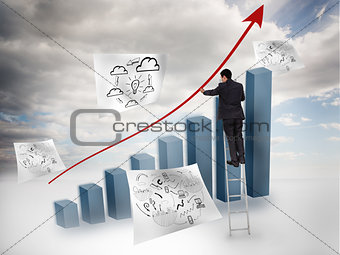 Businessman drawing a red arrow over a chart