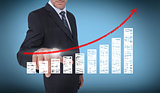Businessman touching a chart with a red arrow pointing up