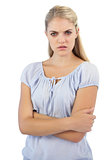 Outraged blonde woman with arms crossed
