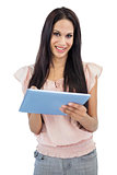 Smiling young woman using tablet pc