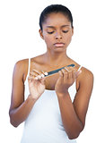 Serious woman using nail file