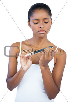 Serious woman using nail file