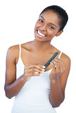 Smiling young woman using nail file