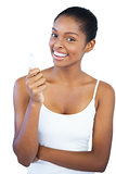 Smiling woman holding her lip balm