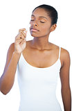 Young woman smelling her lip balm