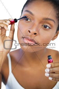 Young woman using mascara for her eyelashes