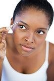 Concentrated woman using tweezers