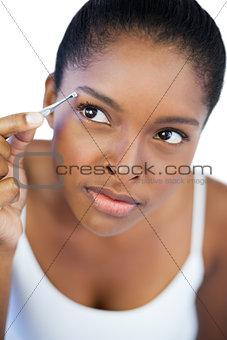 Concentrated woman using tweezers