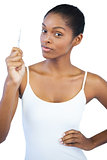Woman with her hand on hip holding tweezers