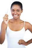 Happy woman with her hand on hip holding tweezers