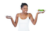 Cheerful woman deciding to eat healthily or not