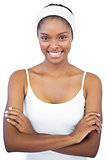 Smiling woman with headband crossing her arms