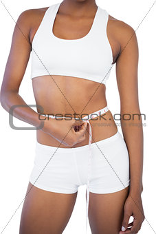 Woman measuring her waist during diet