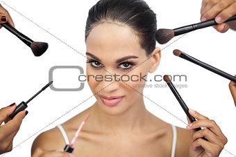 Sexy woman encircled by make up brushes
