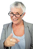 Woman with glasses pointing at camera