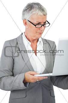 Businesswoman with glasses watching her laptop