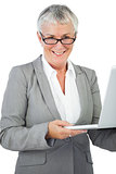 Smiling businesswoman with glasses holding her laptop