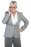 Furious businesswoman calling someone with her hand on hip