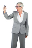 Furious businesswoman screaming during a call