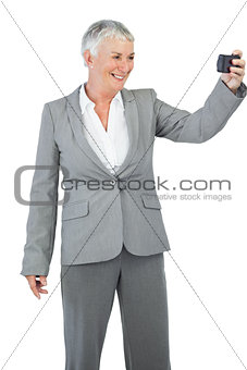 Businesswoman taking picture of herself