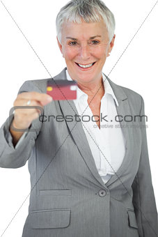 Happy businesswoman showing her credit card