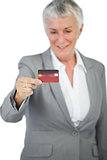 Cheerful businesswoman showing her credit card