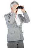 Businesswoman looking at something through binoculars
